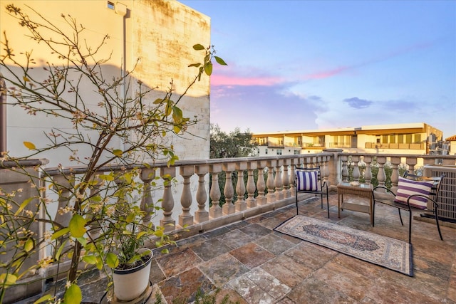 patio terrace at dusk featuring cooling unit