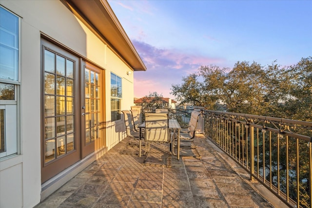 balcony at dusk with outdoor dining area