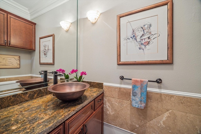 bathroom featuring tile walls, crown molding, and vanity