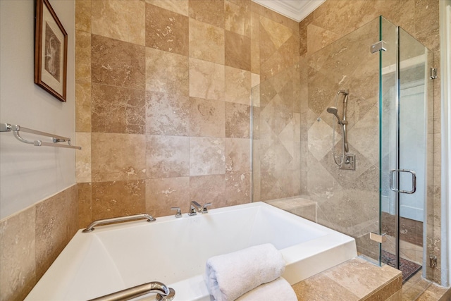 bathroom featuring a stall shower, crown molding, tile walls, and a bath