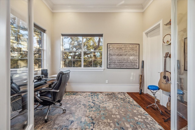 home office featuring baseboards, wood finished floors, a wealth of natural light, and crown molding