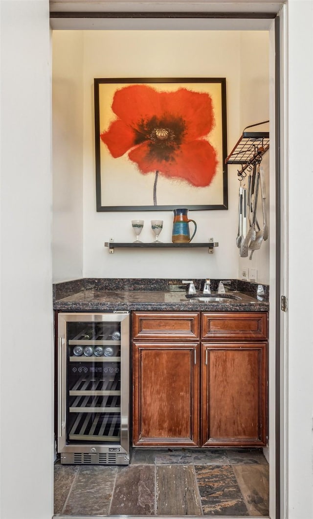 bar with a dry bar, wine cooler, and a sink