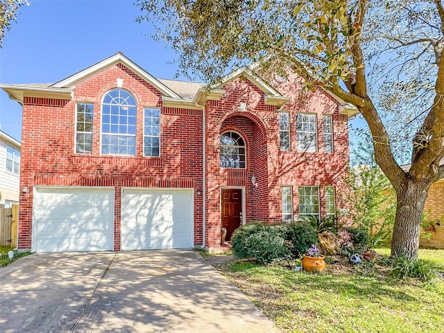 traditional home featuring brick siding, driveway, and an attached garage