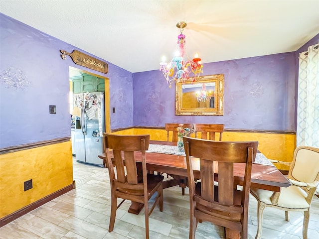 dining room with wainscoting and a notable chandelier