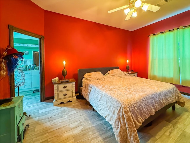 bedroom with wood finished floors, visible vents, and a ceiling fan