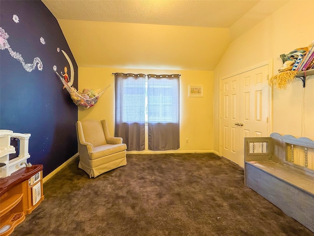 sitting room featuring lofted ceiling, baseboards, and carpet floors