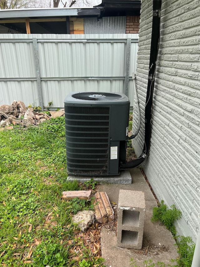 exterior details with central AC and fence