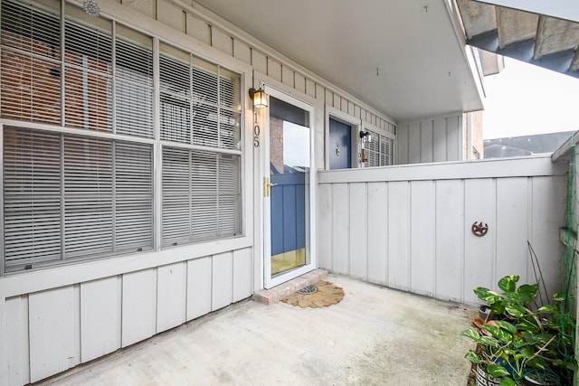 view of exterior entry featuring board and batten siding