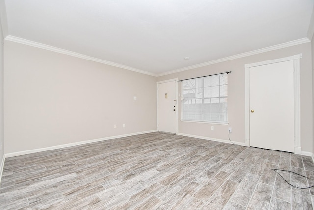 unfurnished room featuring light wood-type flooring, crown molding, and baseboards