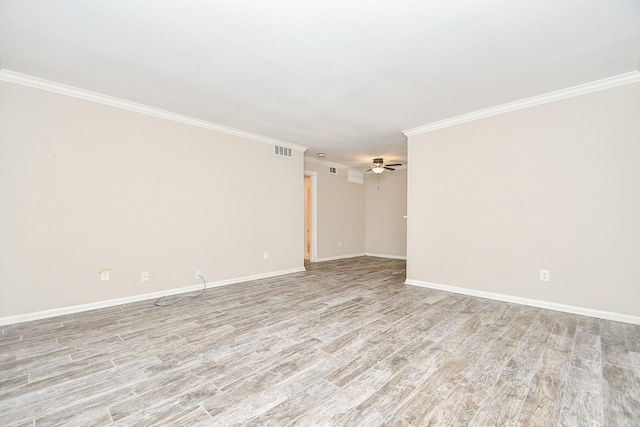 spare room featuring ceiling fan, visible vents, baseboards, ornamental molding, and light wood-type flooring