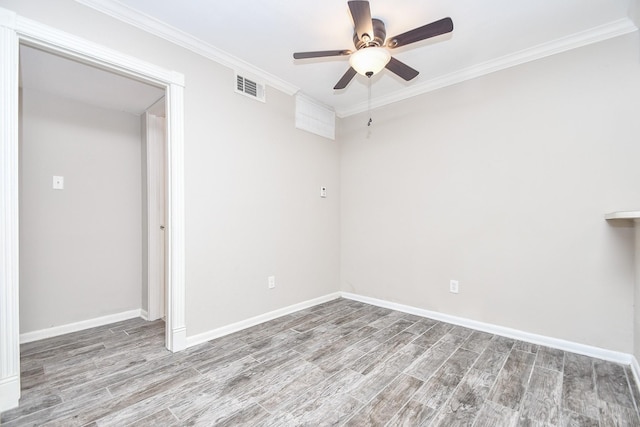 unfurnished room featuring visible vents, ornamental molding, a ceiling fan, wood finished floors, and baseboards