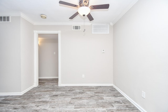 empty room featuring ornamental molding, visible vents, and wood finished floors