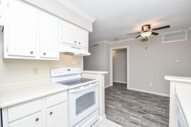 kitchen with under cabinet range hood, white electric stove, visible vents, and ornamental molding