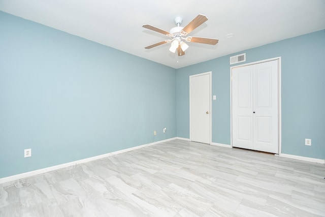 unfurnished bedroom with a ceiling fan, a closet, visible vents, and baseboards