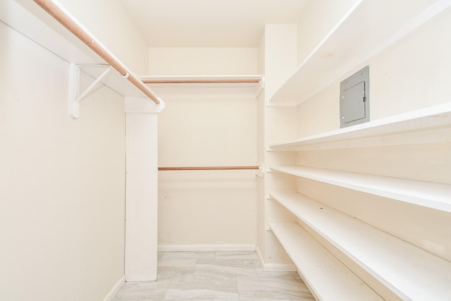 spacious closet featuring marble finish floor