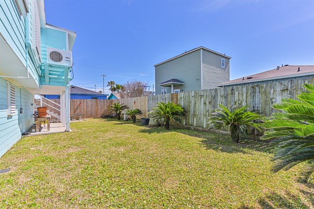 view of yard with a patio area, a fenced backyard, and ac unit