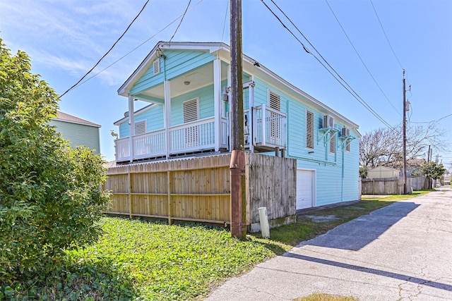 view of front of home with an attached garage, driveway, and fence