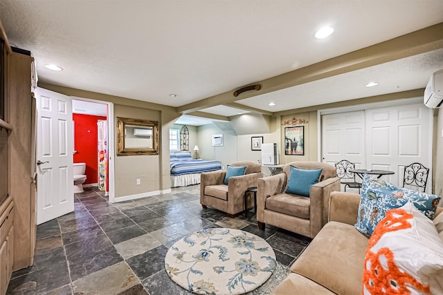 living area with recessed lighting, stone tile flooring, and baseboards