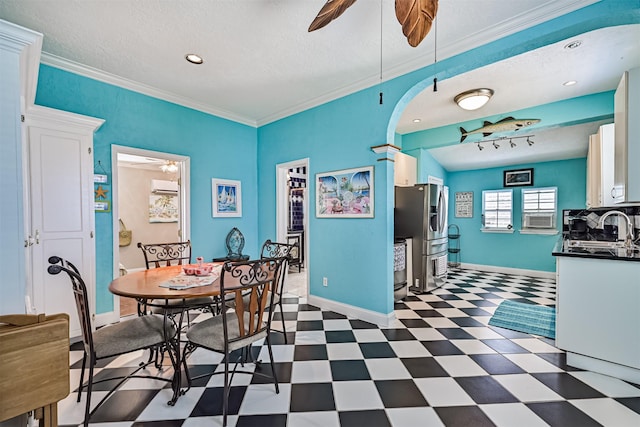 dining area featuring ceiling fan, dark floors, baseboards, and crown molding