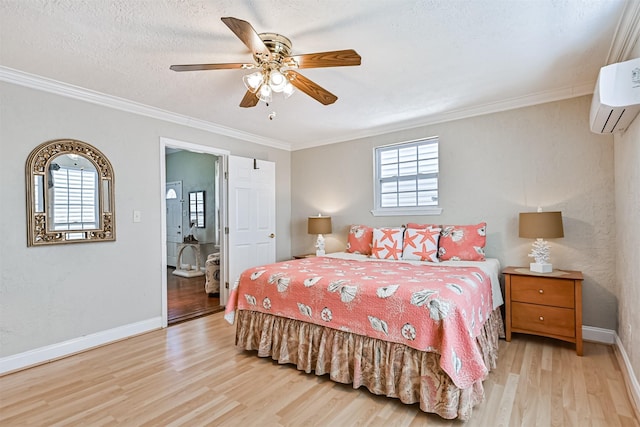 bedroom with crown molding, a wall mounted AC, a textured ceiling, wood finished floors, and baseboards