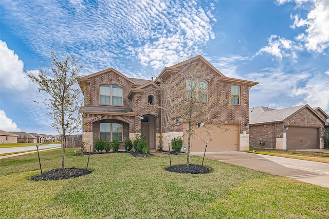 traditional home with an attached garage, concrete driveway, brick siding, and a front yard