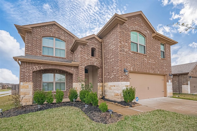 view of front of property featuring an attached garage, stone siding, and brick siding