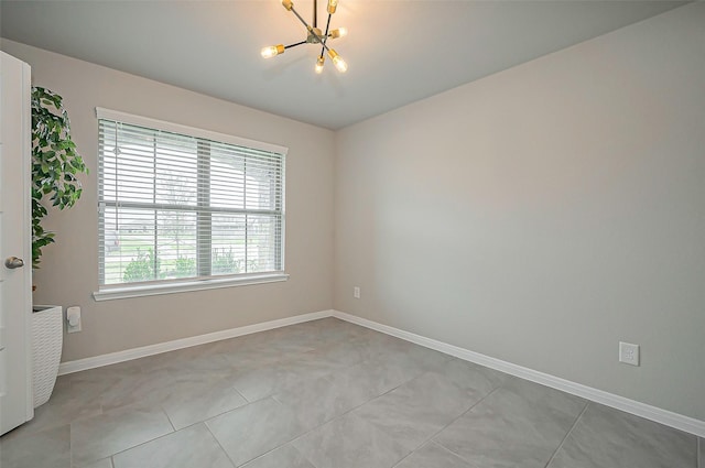 unfurnished room featuring light tile patterned floors, baseboards, and an inviting chandelier