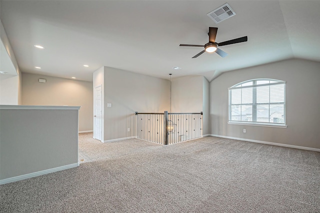 carpeted spare room featuring recessed lighting, a ceiling fan, visible vents, vaulted ceiling, and baseboards