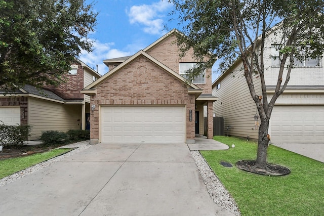 traditional-style house featuring a garage, concrete driveway, brick siding, and a front lawn