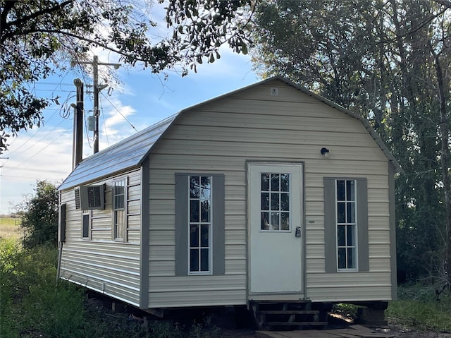 view of outdoor structure with entry steps and an outbuilding