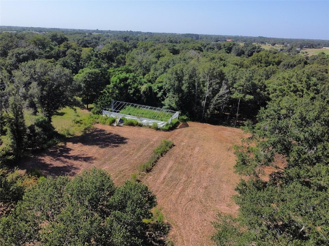 birds eye view of property with a wooded view