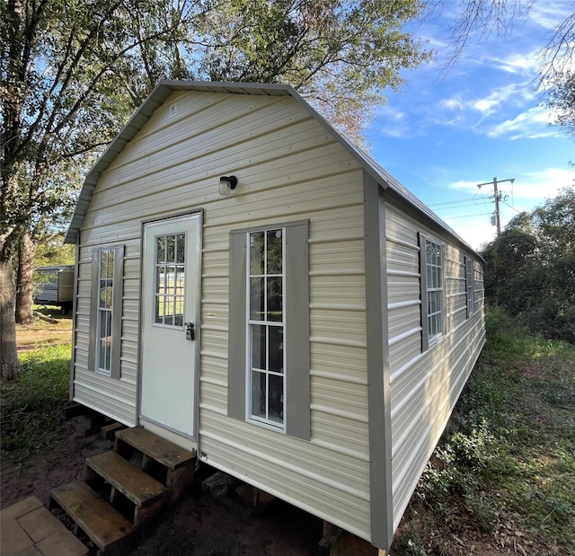 view of outdoor structure featuring entry steps and an outbuilding