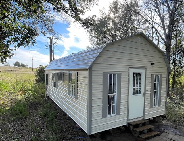 view of outbuilding with entry steps and an outbuilding