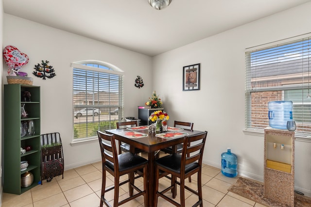 dining space featuring light tile patterned floors and baseboards