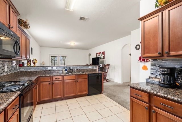 kitchen with arched walkways, visible vents, light carpet, a sink, and black appliances