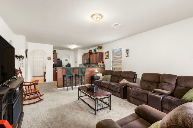 living area with light colored carpet and visible vents