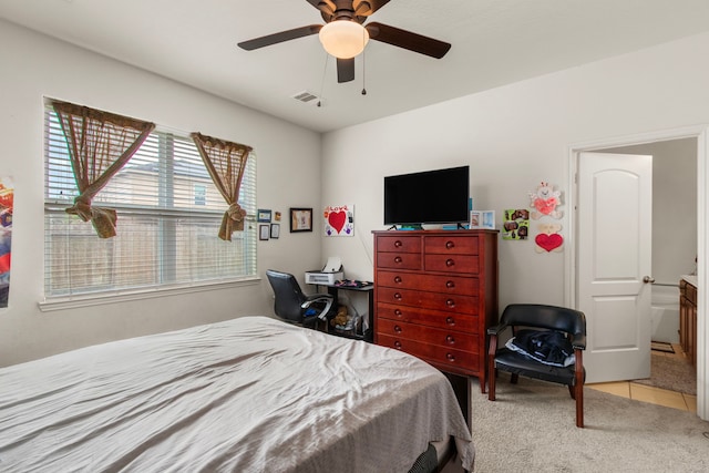 tiled bedroom with ceiling fan, visible vents, and carpet flooring