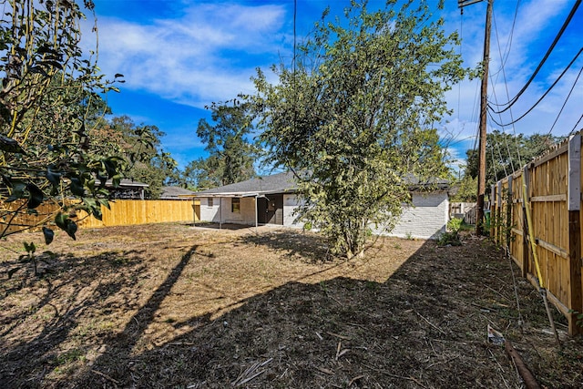 back of house featuring a fenced backyard