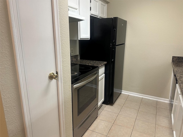 kitchen with light tile patterned floors, electric range, baseboards, under cabinet range hood, and white cabinetry