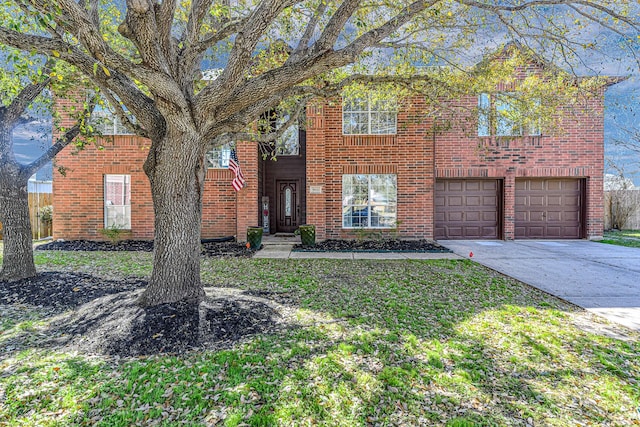 traditional-style house with a garage, a front yard, concrete driveway, and brick siding