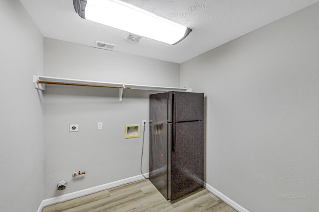 laundry room with washer hookup, visible vents, light wood-style floors, electric dryer hookup, and laundry area