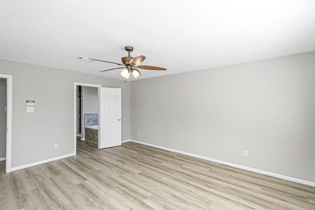 unfurnished room with light wood-style floors, baseboards, and a ceiling fan