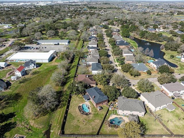 birds eye view of property with a water view and a residential view