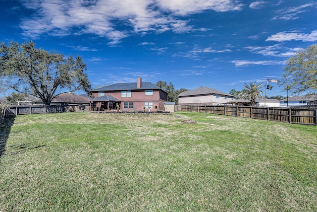 view of yard with a fenced backyard and a gazebo