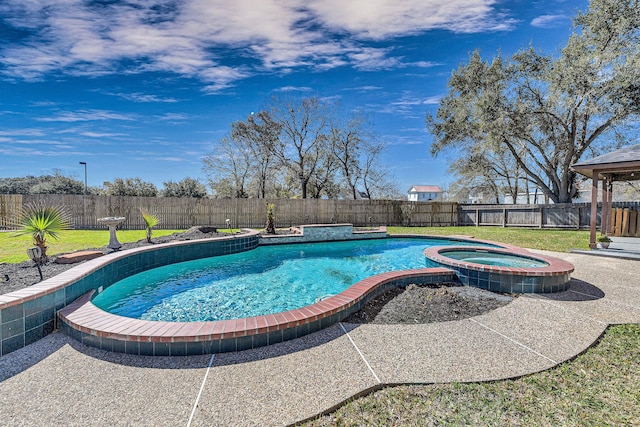 view of pool featuring a lawn, a fenced backyard, and a pool with connected hot tub