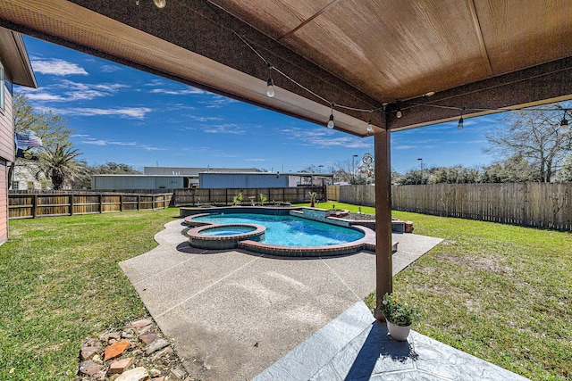 view of pool with a pool with connected hot tub, a fenced backyard, a yard, and a patio