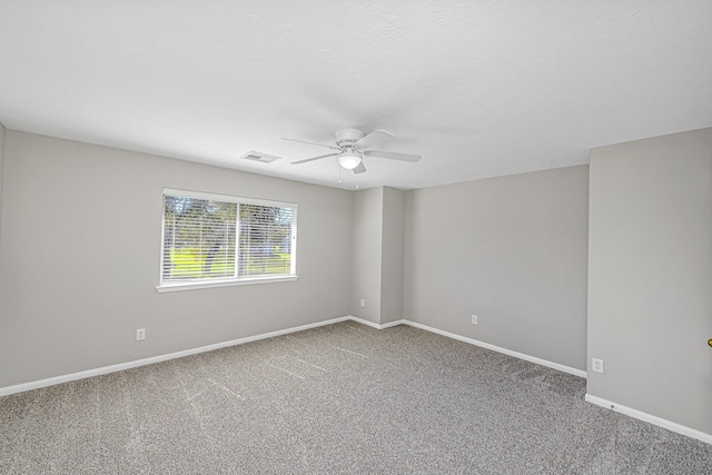 empty room featuring baseboards, visible vents, ceiling fan, a textured ceiling, and carpet flooring