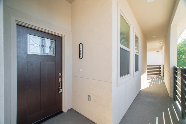 property entrance with stucco siding