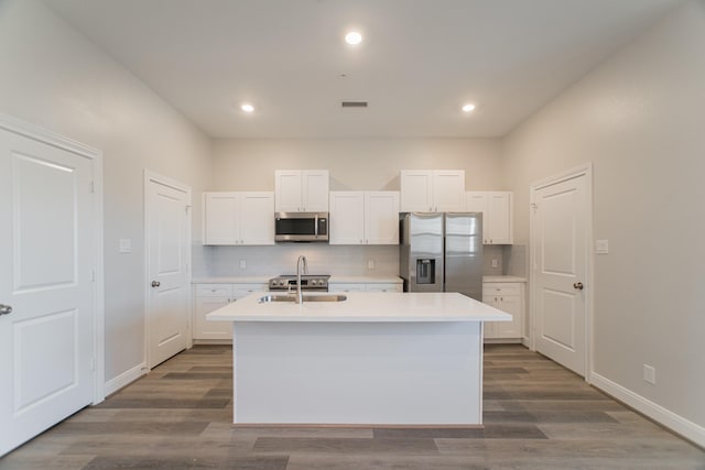 kitchen with white cabinetry, appliances with stainless steel finishes, tasteful backsplash, and a sink