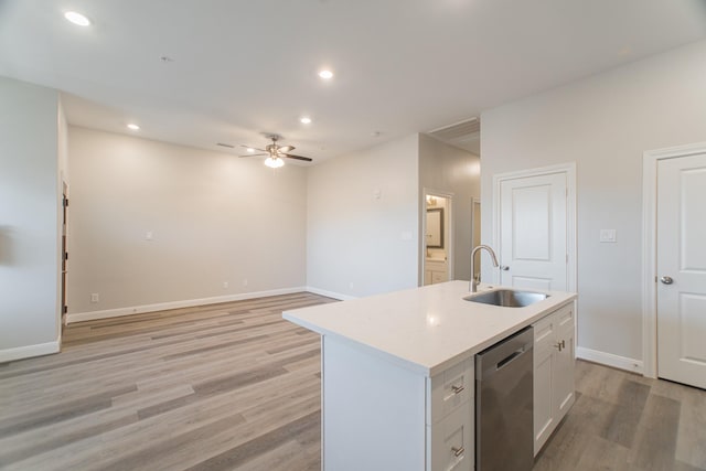 kitchen featuring light wood-style flooring, recessed lighting, a sink, light countertops, and stainless steel dishwasher